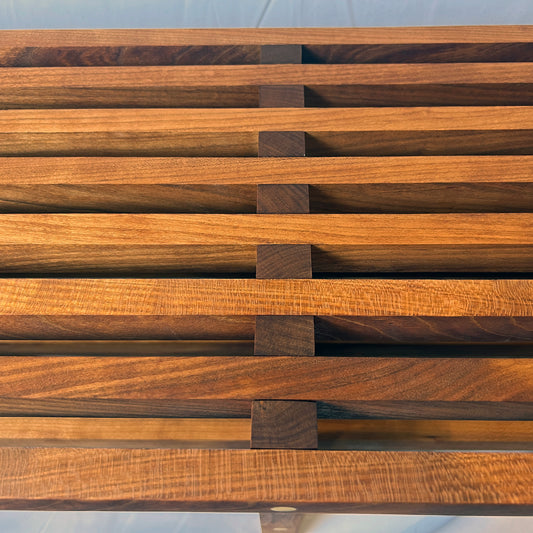 Wooden slat wall with a grid pattern on a white background