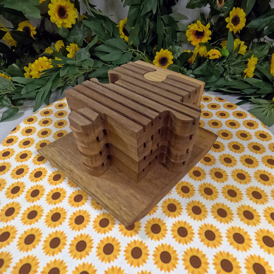 Wooden puzzle-shaped trivets on a tablecloth with sunflower pattern