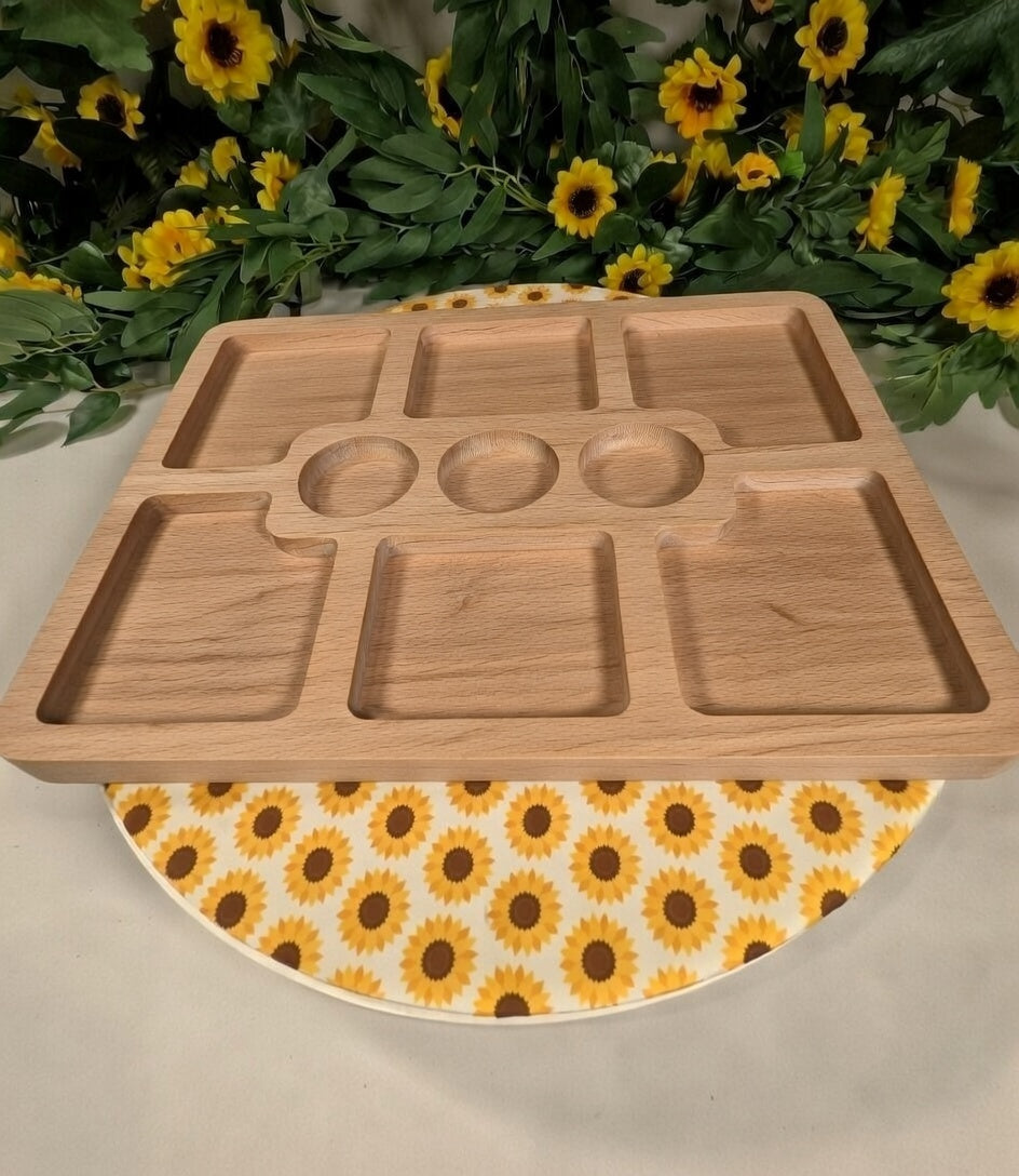 Wooden tray with compartments on a sunflower-patterned surface
