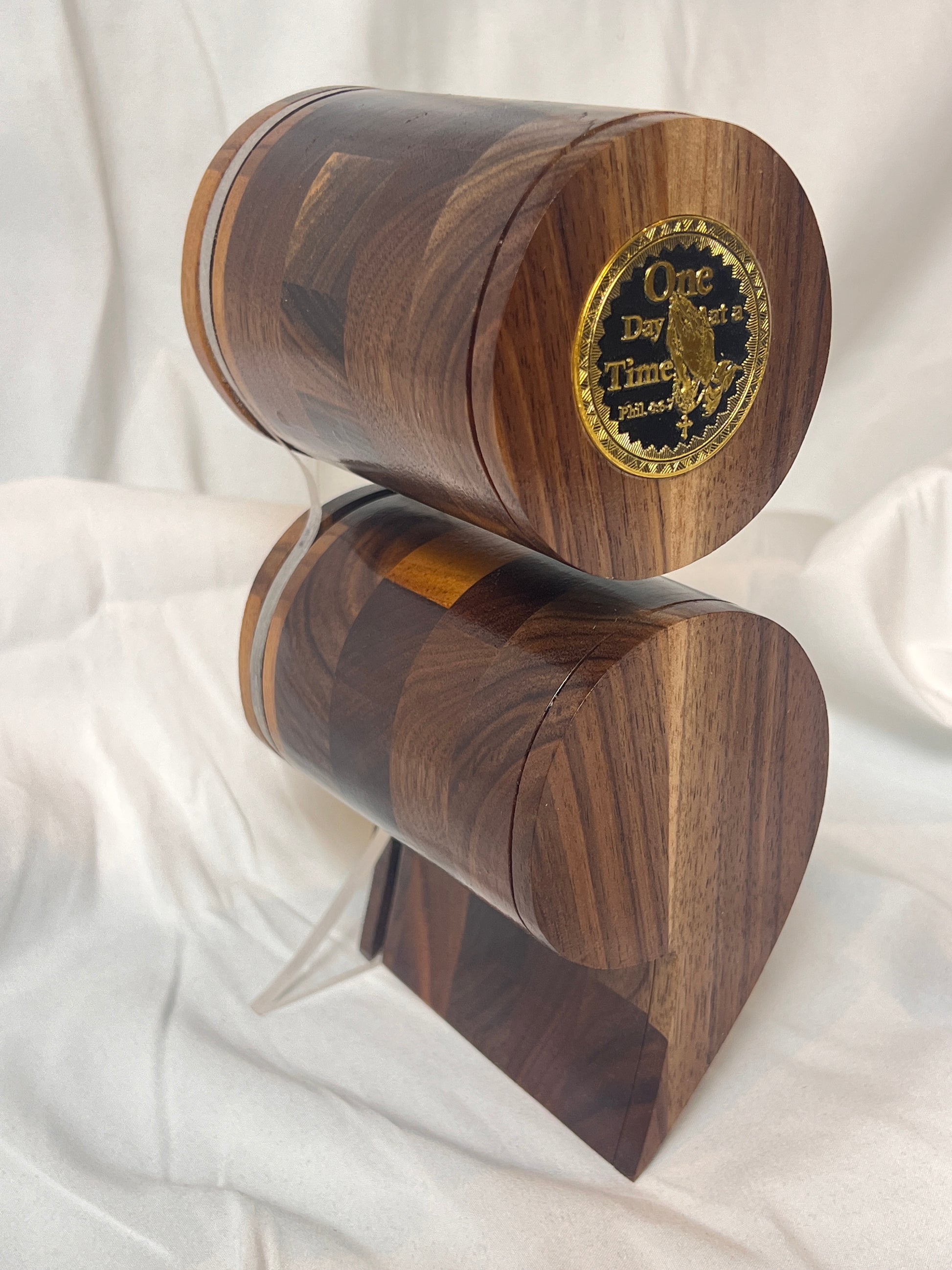 A black walnut semicolon keepsake box with a gold and black "One Day at a Time" coin embedded on the top.