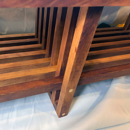 Close-up of a wooden bench with slatted design on a white background