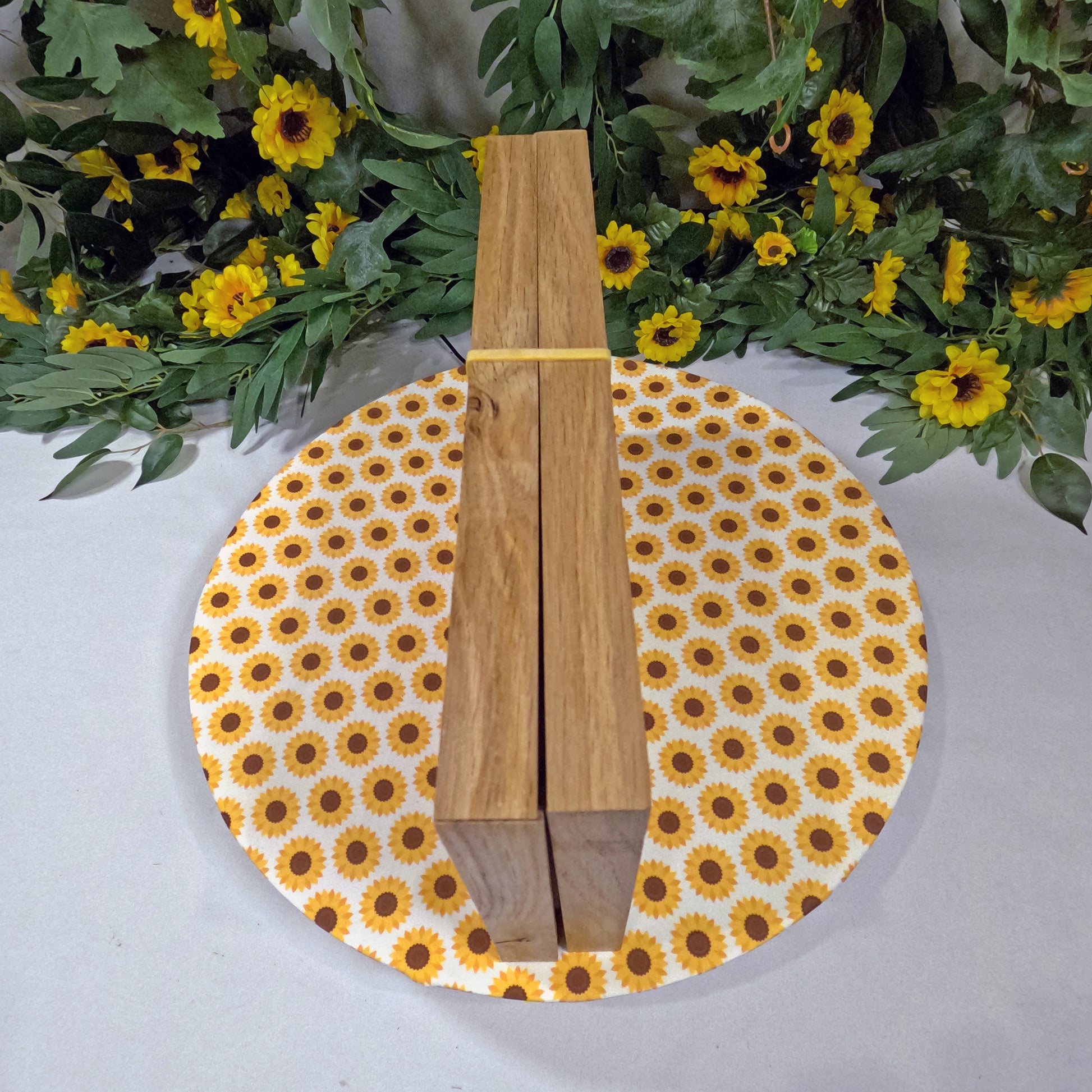 Wooden game set on a round sunflower-patterned placemat with floral background