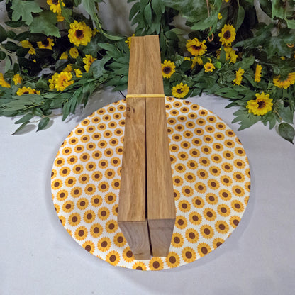 Wooden game set on a round sunflower-patterned placemat with floral background