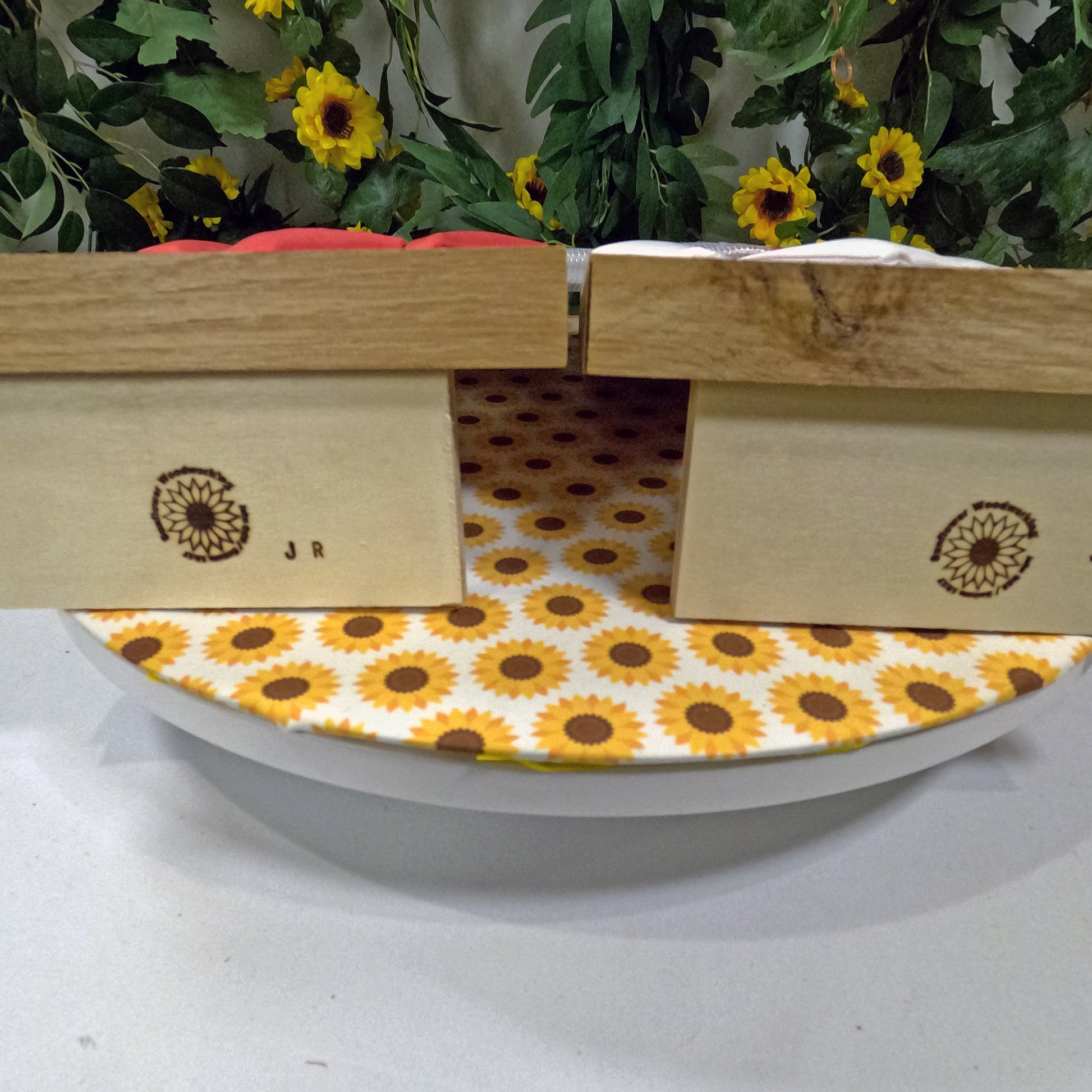 Wooden cornhole set with floral pattern on a white surface
