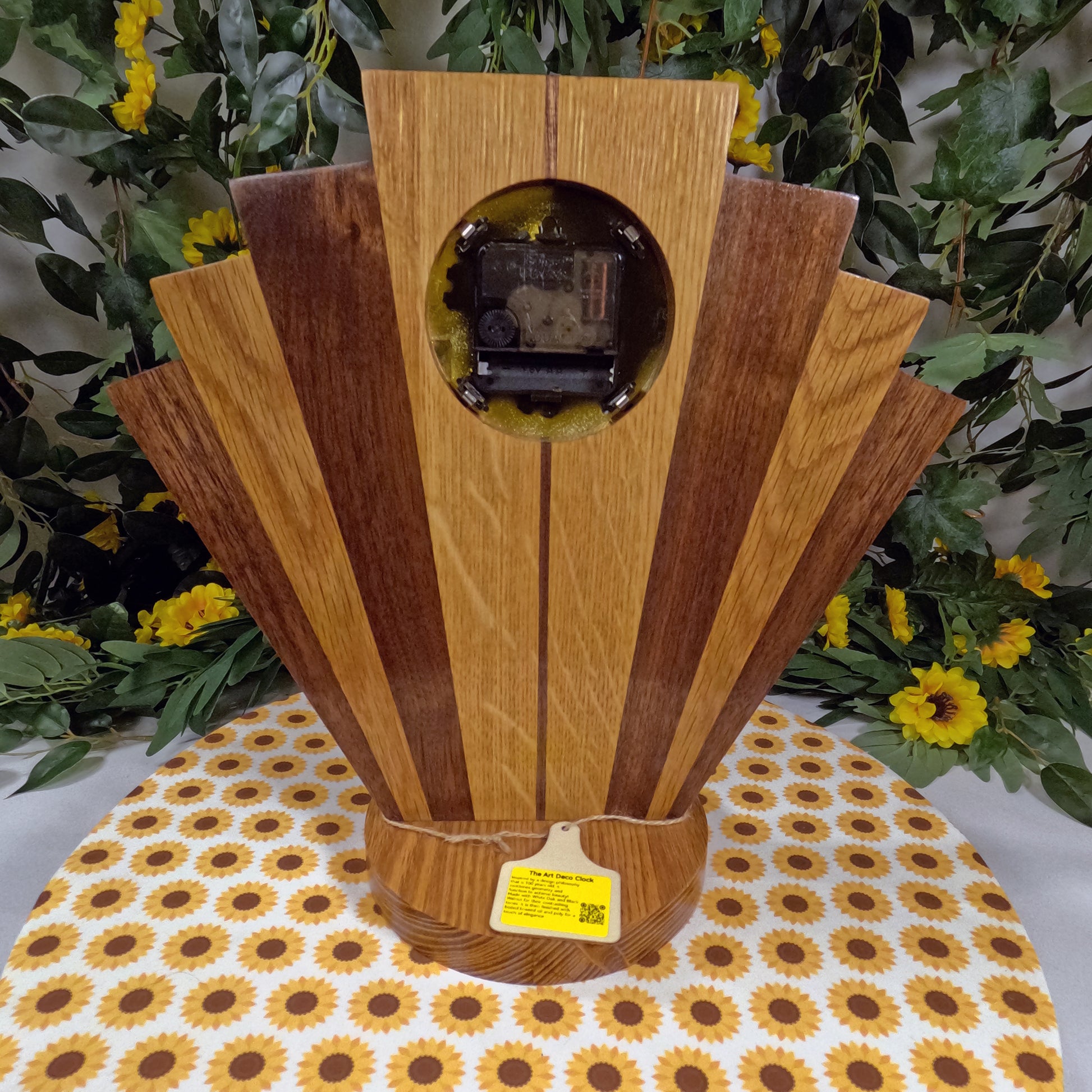 Wooden clock with a circular design on a tablecloth with sunflower pattern