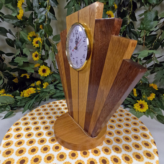 Wooden clock with a decorative stand on a tablecloth with sunflower pattern