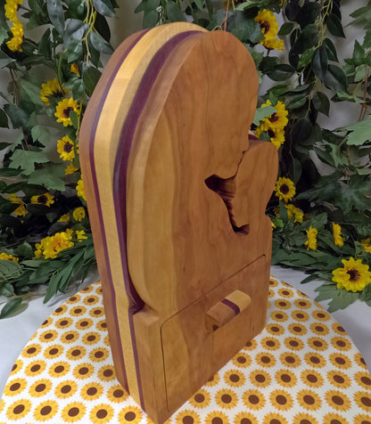 Wooden product with purple accents on a floral tablecloth with a floral background