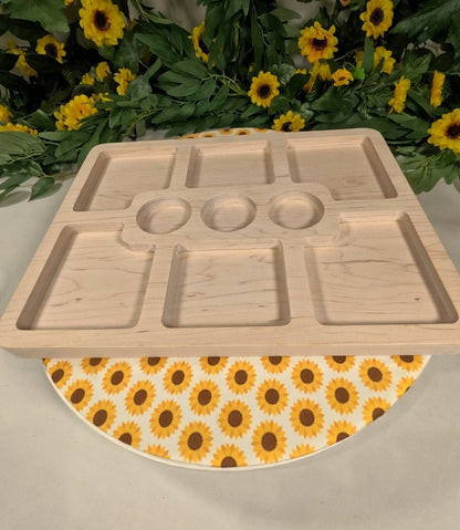 Wooden tray with compartments on a sunflower-patterned mat with sunflowers in the background