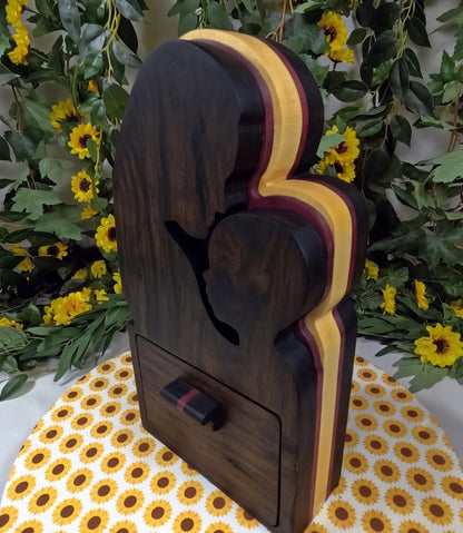 Wooden product with a black silhouette on a floral tablecloth