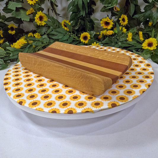 Wooden tray on a sunflower-patterned plate with floral decorations in the background