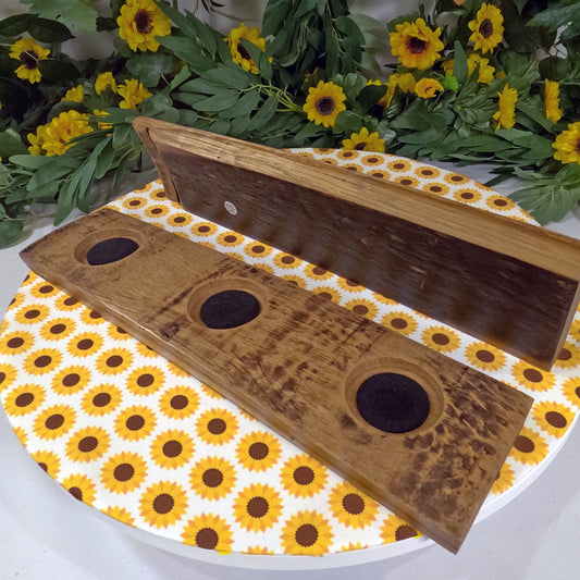 Wooden board with circular holes on a sunflower-patterned surface