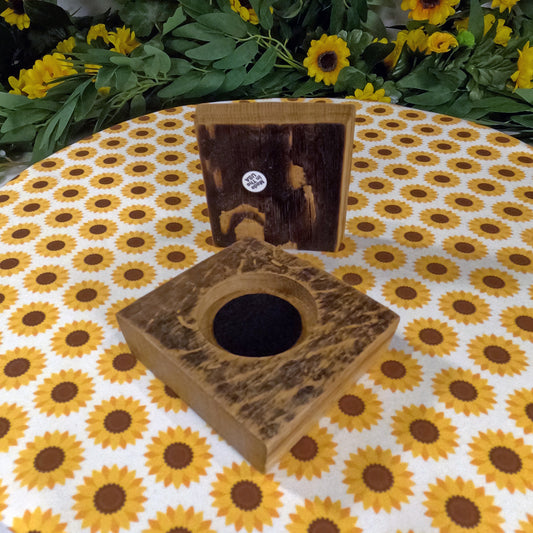 Wooden product with a circular hole on a tablecloth with sunflower pattern