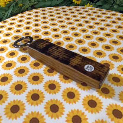 Wooden bottle opener on a sunflower-patterned fabric