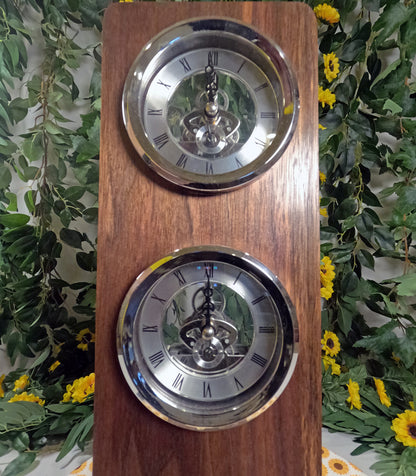 Wooden clock with two silver faces against a floral background