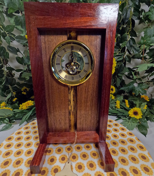 Wooden clock with gold face on a floral-patterned surface