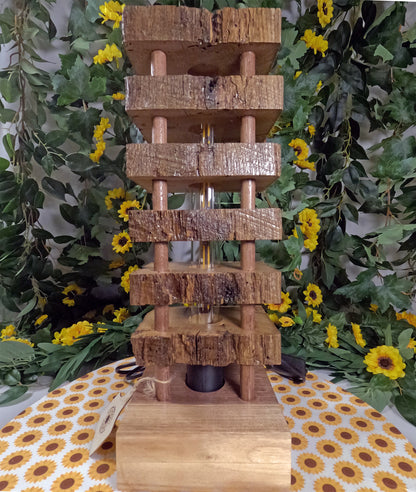 Wooden tiered display with a floral and greenery background