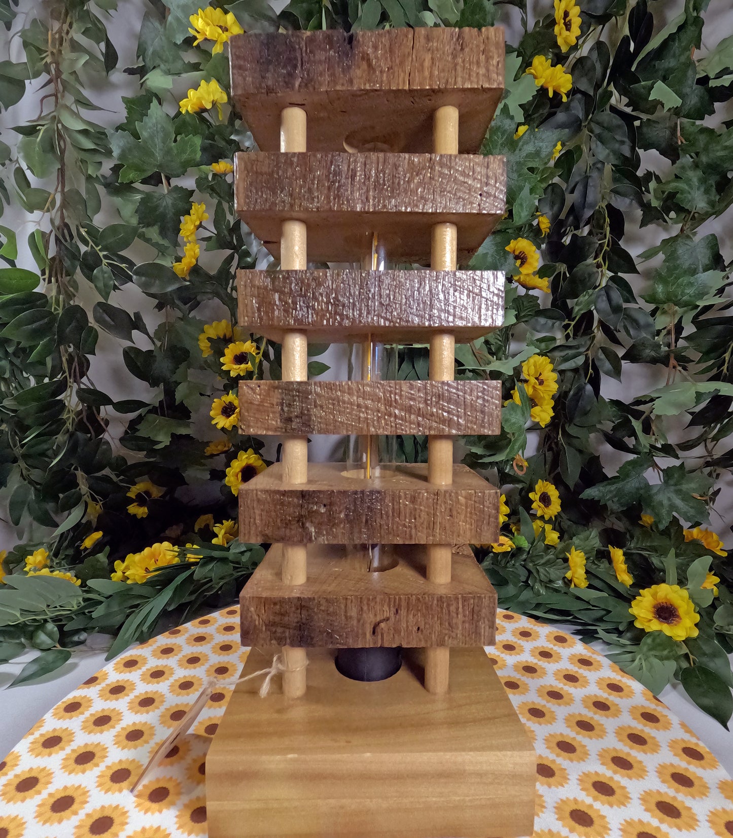 Wooden tiered display with a floral and leafy background