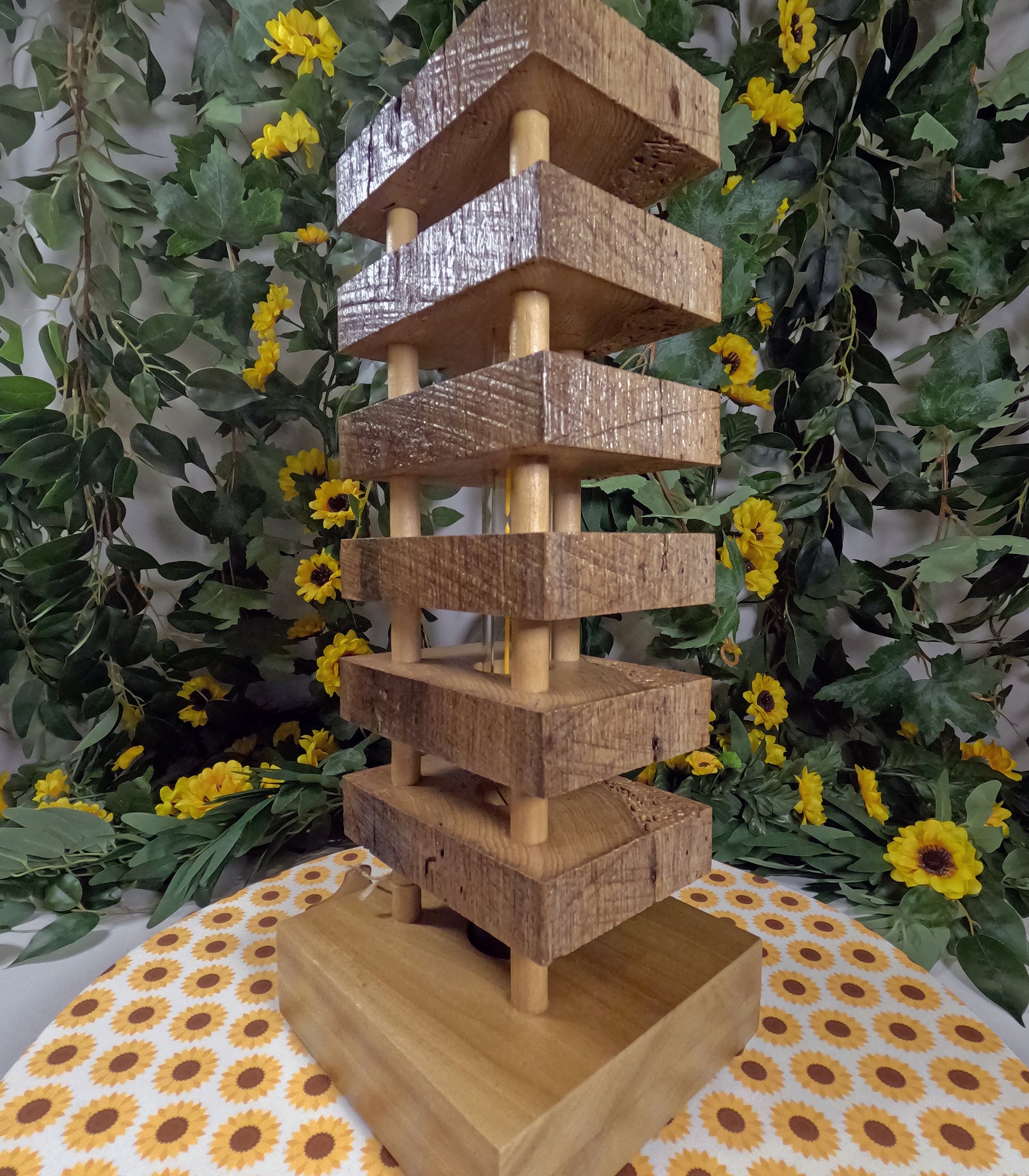 Wooden tiered display stand with a floral and polka dot tablecloth background