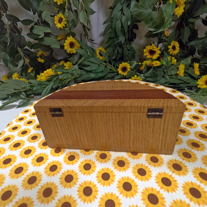 Wooden box on a tablecloth with sunflower pattern and floral background