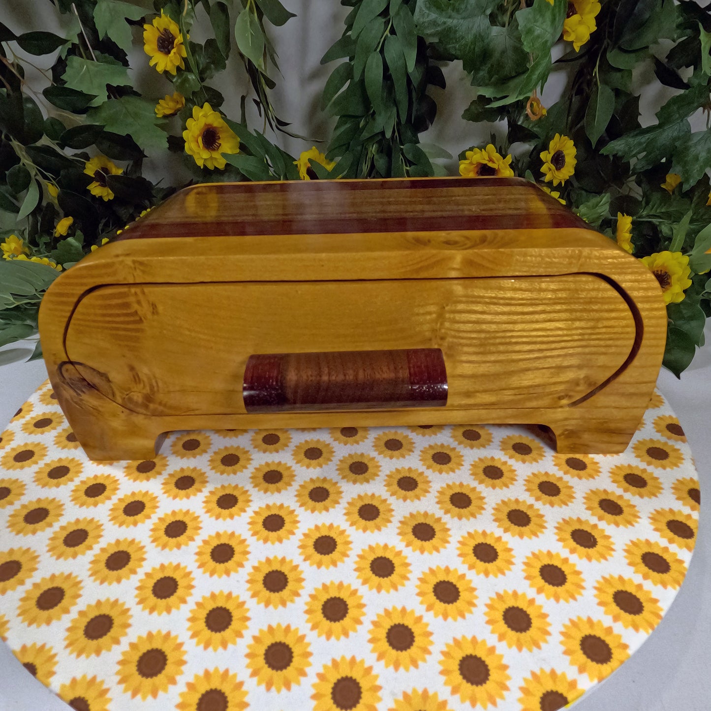 Wooden box with a floral patterned surface underneath