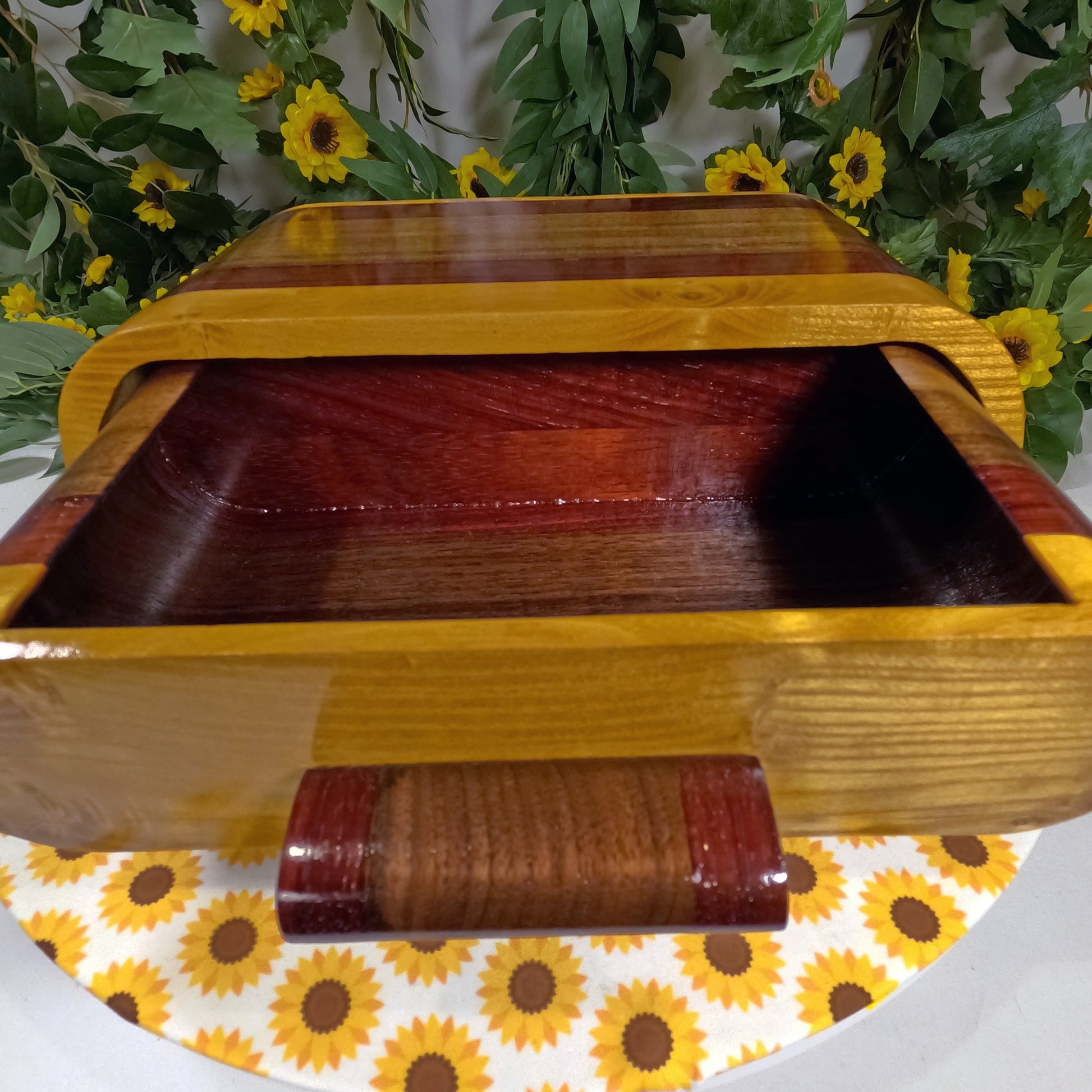 Wooden box with a floral and sunflower patterned surface underneath
