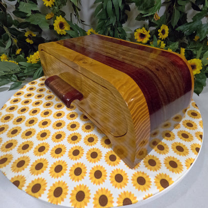 Wooden box with wavy design on a sunflower-patterned tablecloth
