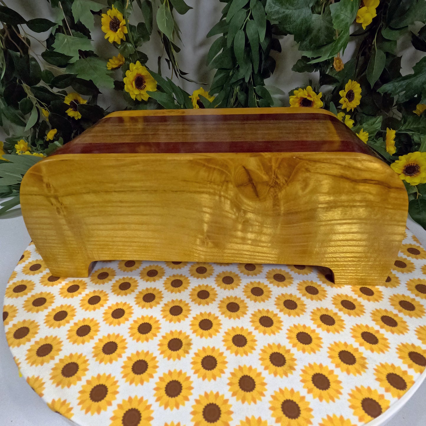 Wooden box on a table with sunflower patterned paper and floral background
