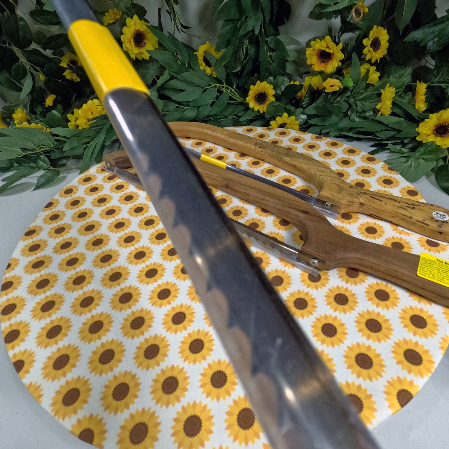 Bread saws on a sunflower-patterned mat with greenery in the background