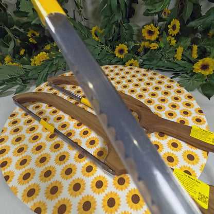 Serrated knife on a floral-patterned cutting board with sunflower design