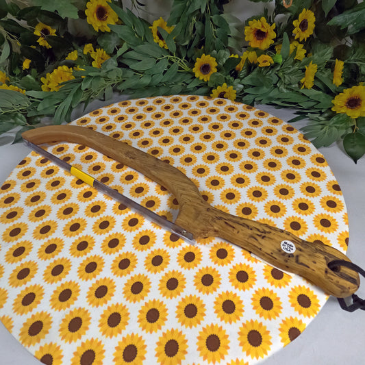 Saw on a sunflower-patterned mat with flowers and leaves in the background