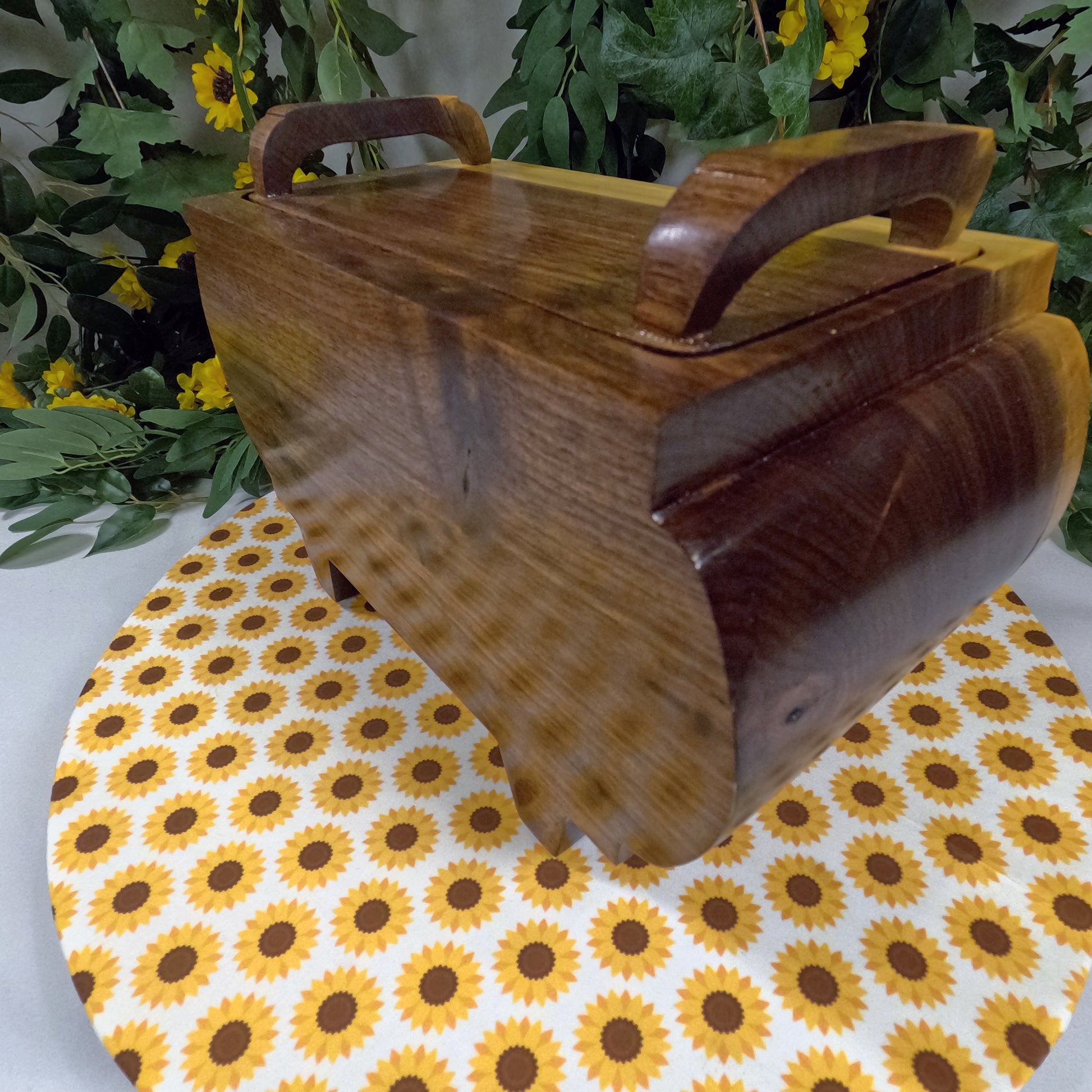 Wooden box with handles on a sunflower-patterned tablecloth