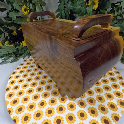 Wooden box with handles on a sunflower-patterned tablecloth