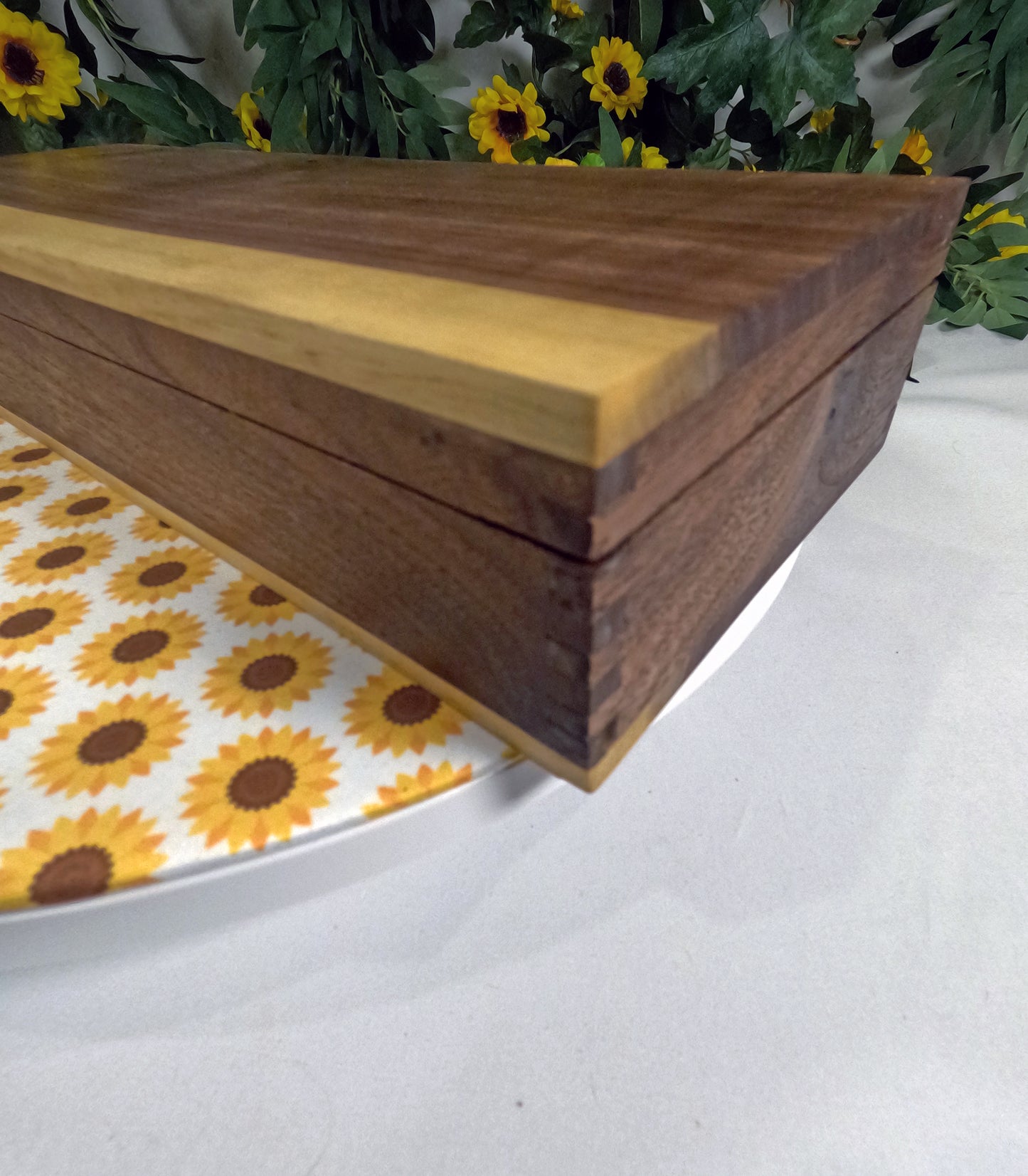 Wooden box with a sunflower-patterned fabric underneath