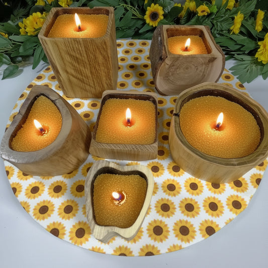 Set of wooden containers with black interiors on a sunflower-patterned mat.