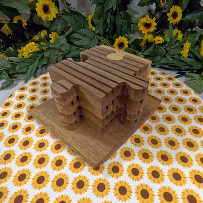 Wooden puzzle-shaped trivets on a tablecloth with sunflower pattern