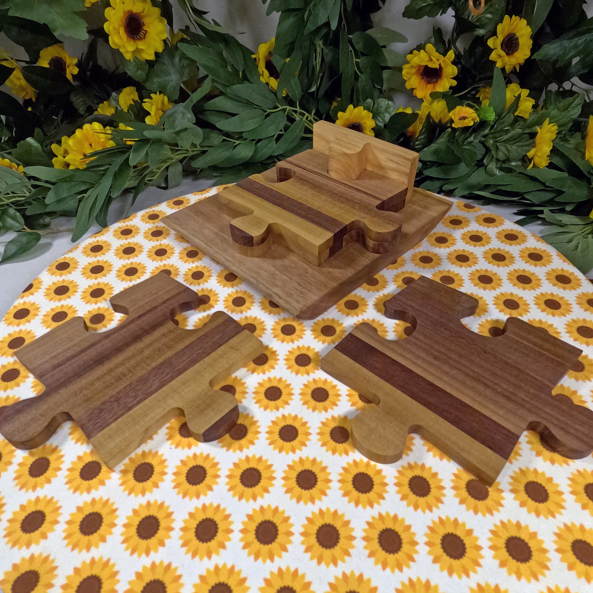 Wooden puzzle coasters on a tablecloth with sunflower pattern