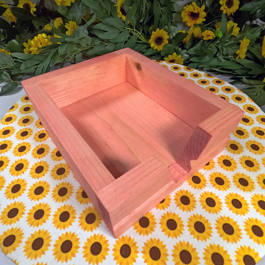 Wooden box on a tablecloth with sunflower pattern