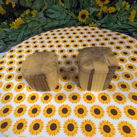 Two wooden boxes on a tablecloth with sunflower pattern