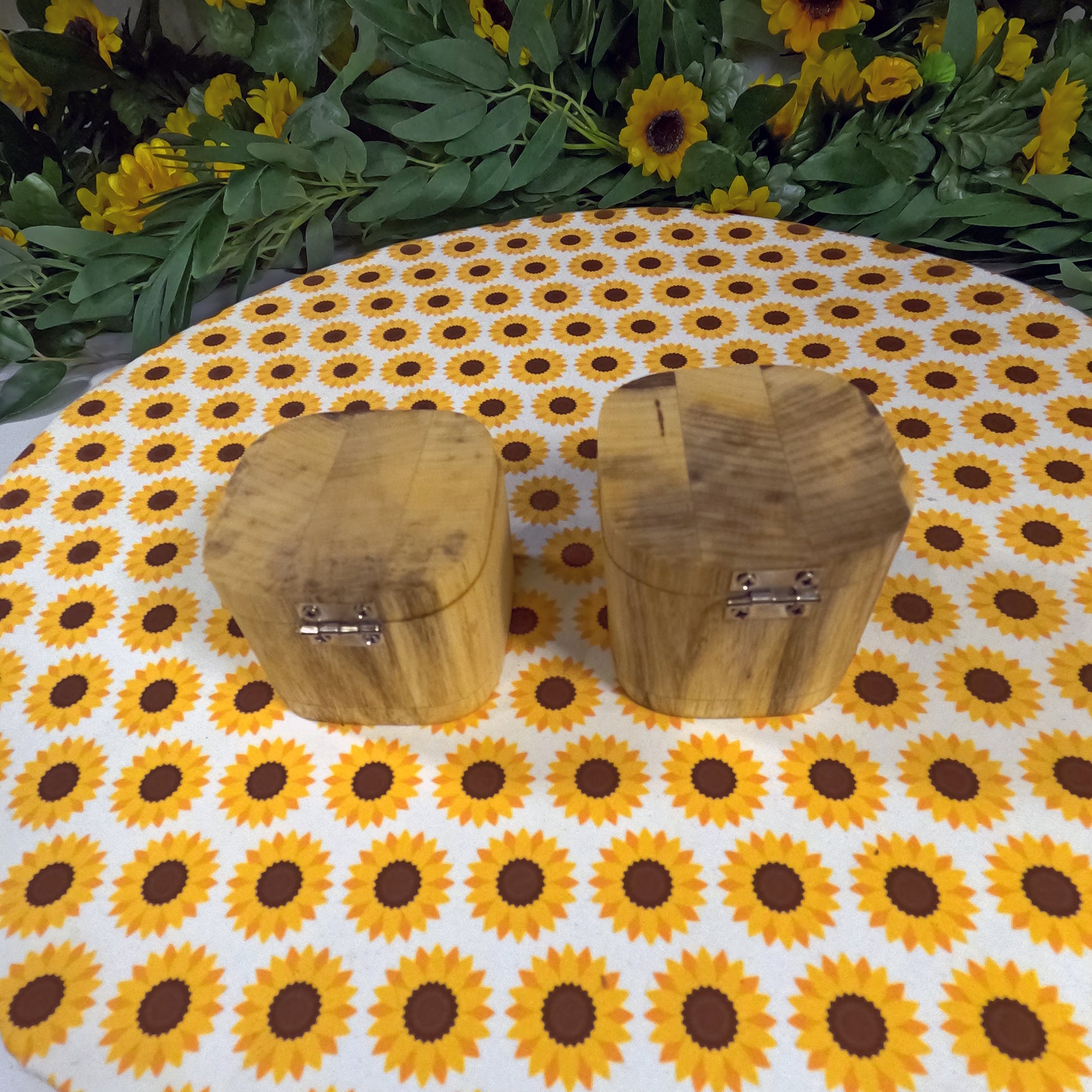 Two wooden boxes on a tablecloth with sunflower pattern