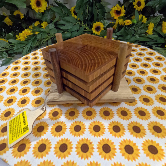Wooden coaster set on a tablecloth with sunflower pattern