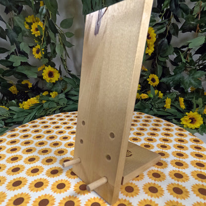 Wooden phone stand with floral and greenery background
