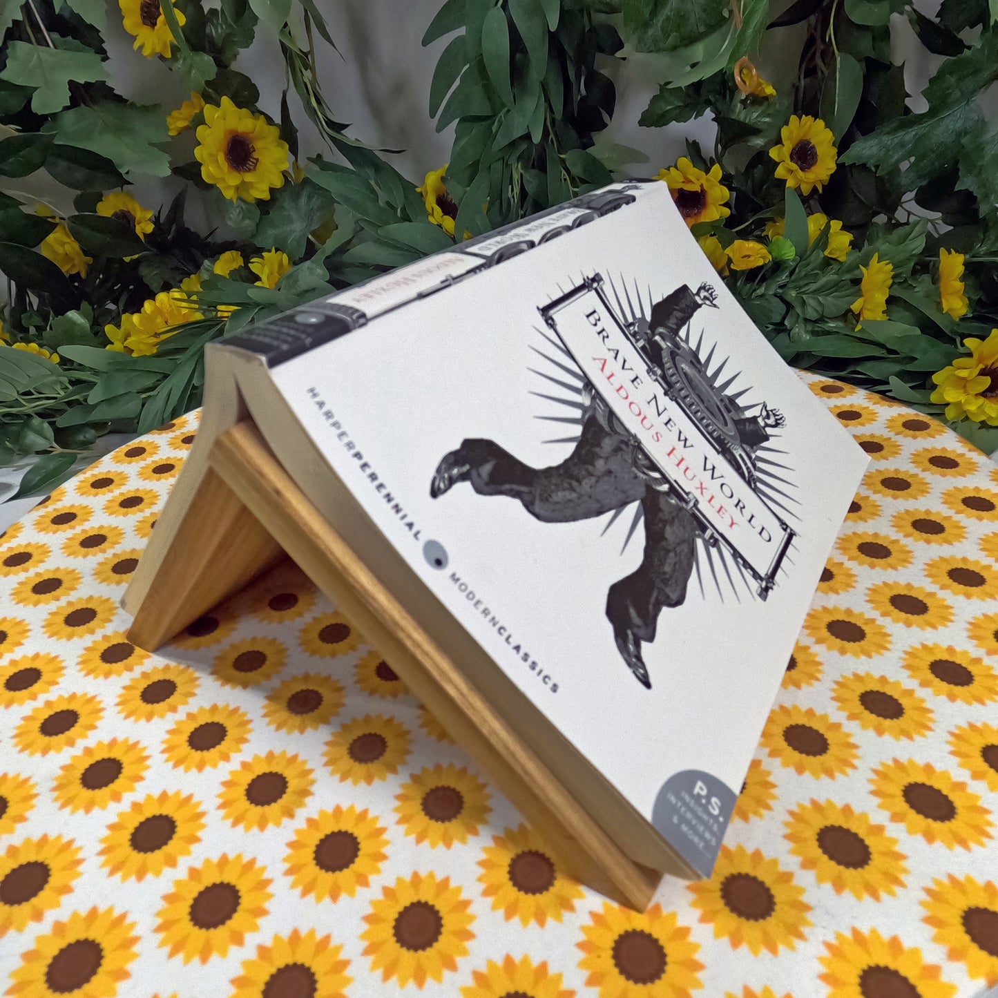 Book with a decorative cover featuring an eagle illustration on a sunflower-patterned surface.