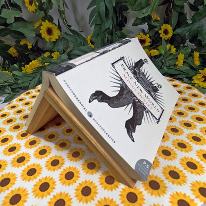 Book with a decorative cover featuring an eagle illustration on a sunflower-patterned surface.