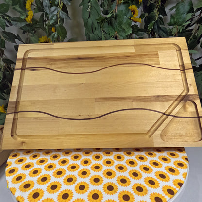 Wooden cutting board on a table with sunflower patterned cloth underneath