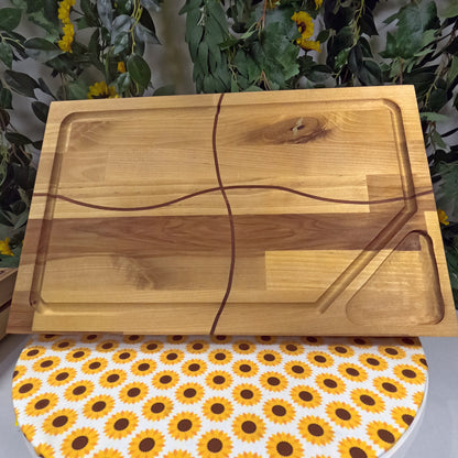 Wooden cutting board on a surface with sunflower pattern