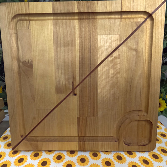 Wooden cutting board on a tablecloth with sunflower pattern
