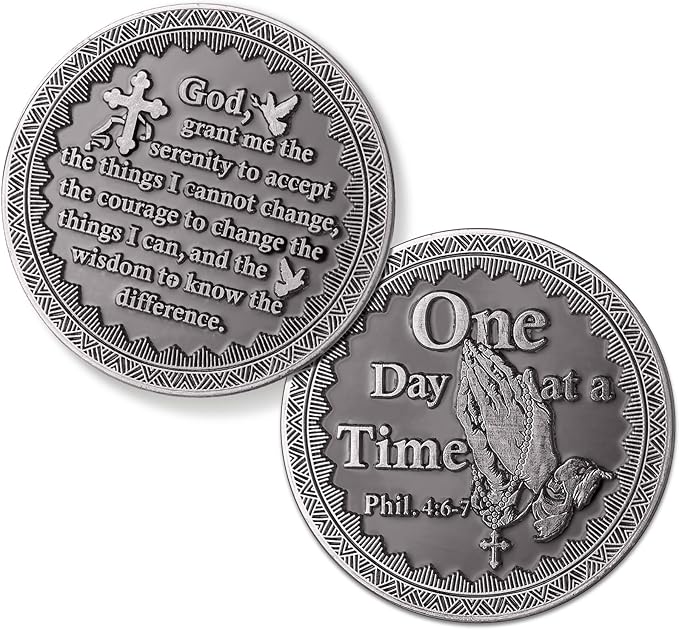 Two silver coins with engraved text and designs on a white background