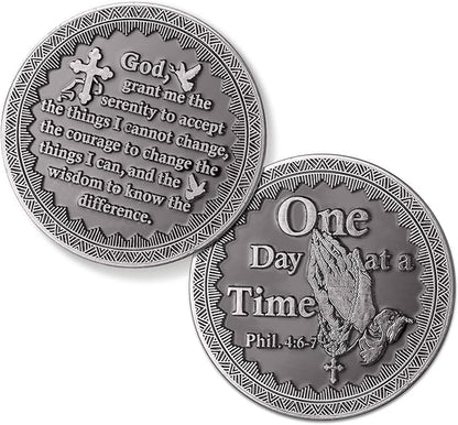 Two silver coins with engraved text and designs on a white background