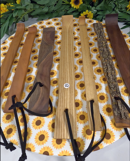Set of wooden tools with leather straps on a sunflower-patterned mat