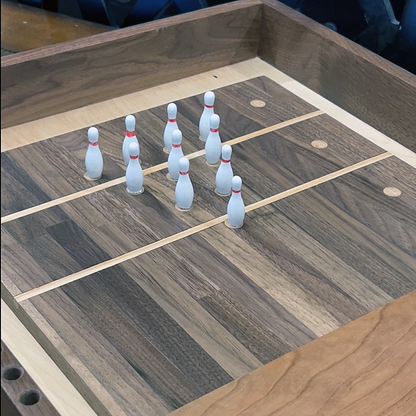Bowling pins arranged on a wooden surface with a checkered pattern